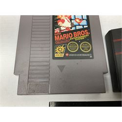 Nintendo Entertainment System (1985) console with two controllers, accessories and instruction booklet. NES Games ‘Duck Hunt’ with Nintendo Zapper gun, ‘Pinball’ and ‘Super Mario Bros.’, all with original sleeves and instruction booklets. NES game ‘Super Mario Bros. 2’ cartridge only