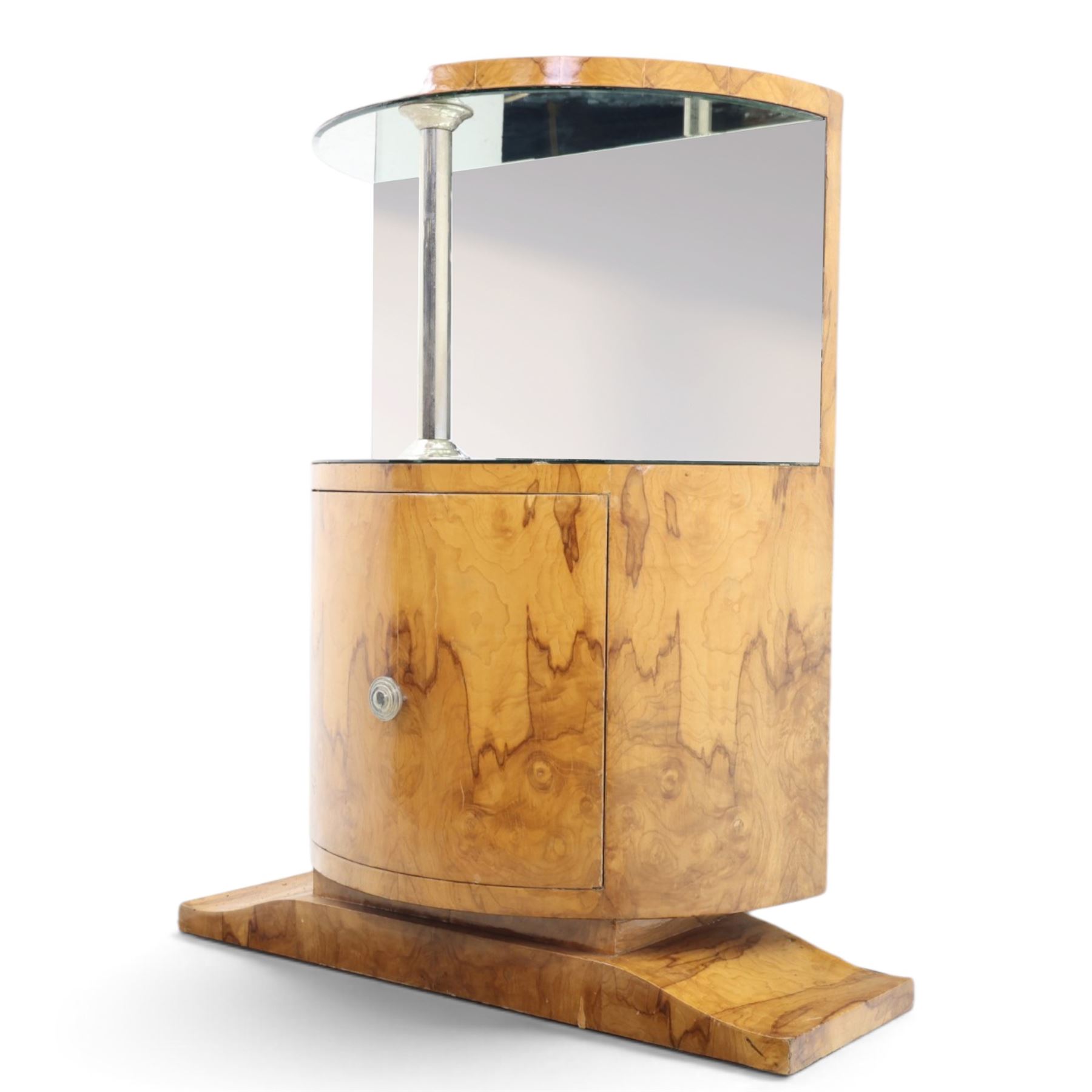 Art Deco figured walnut cocktail cabinet, demi-lune top above mirrored open compartment supported by chrome column, enclosed cupboard below with curved door, on shaped plinth base