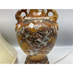 20th century Japanese vase converted to a lamp, the baluster form body decorated with samurai warriors and blossoming branches with twin handles, with wood base and fixtures, with tasselled fabric shade, H56cm excl shade
