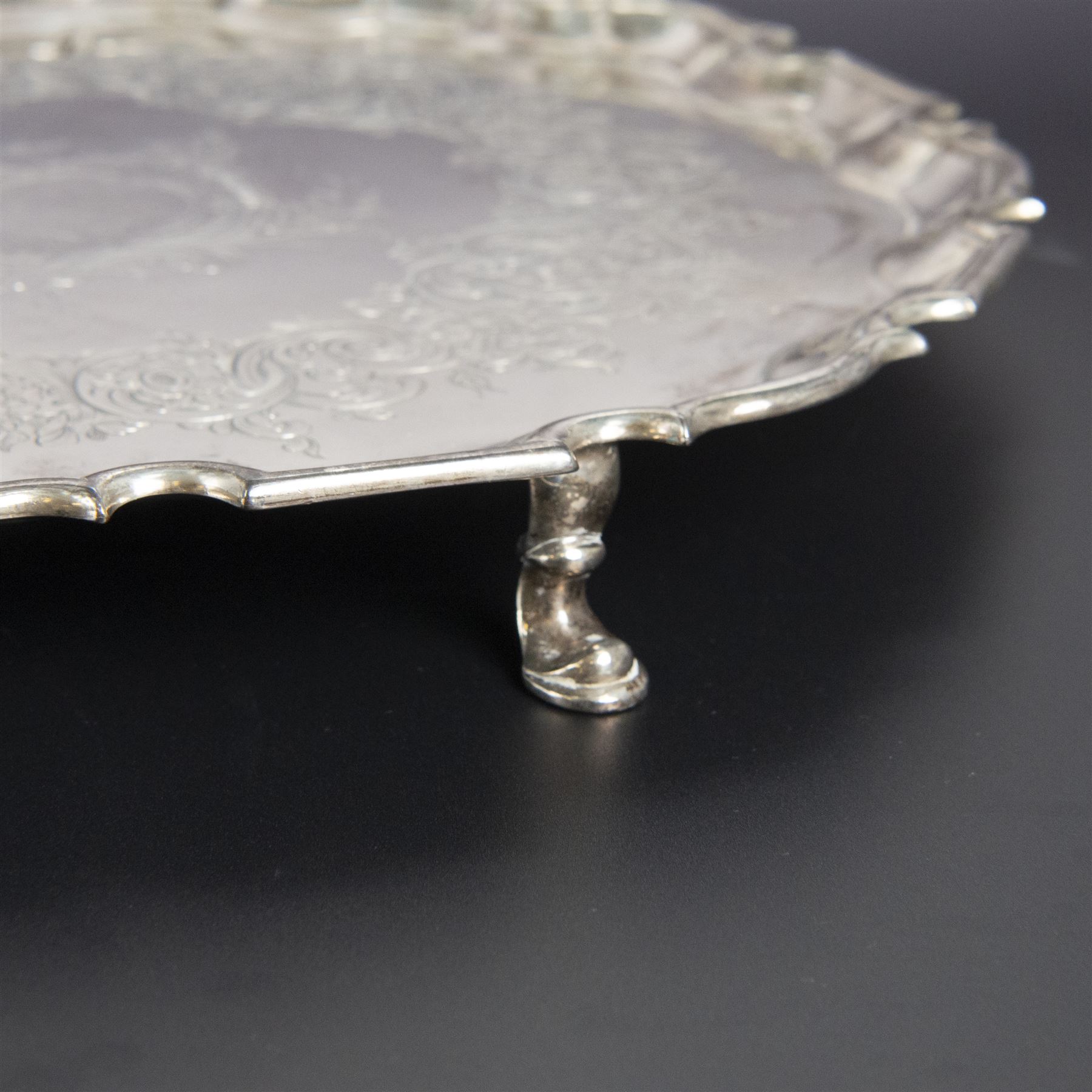 George II silver salver, of circular form with pie crust rim, with later floral and foliate decoration and presentation engraving to centre, upon three stepped feet, hallmarked William Peaston, London 1749, D30cm