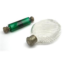 A Victorian doubled ended emerald glass scent bottle, the faceted body with silver coloured foliate chased caps, L12.5cm, together with  later moulded clear glass bottle with wrythern moulded body, H14cm.