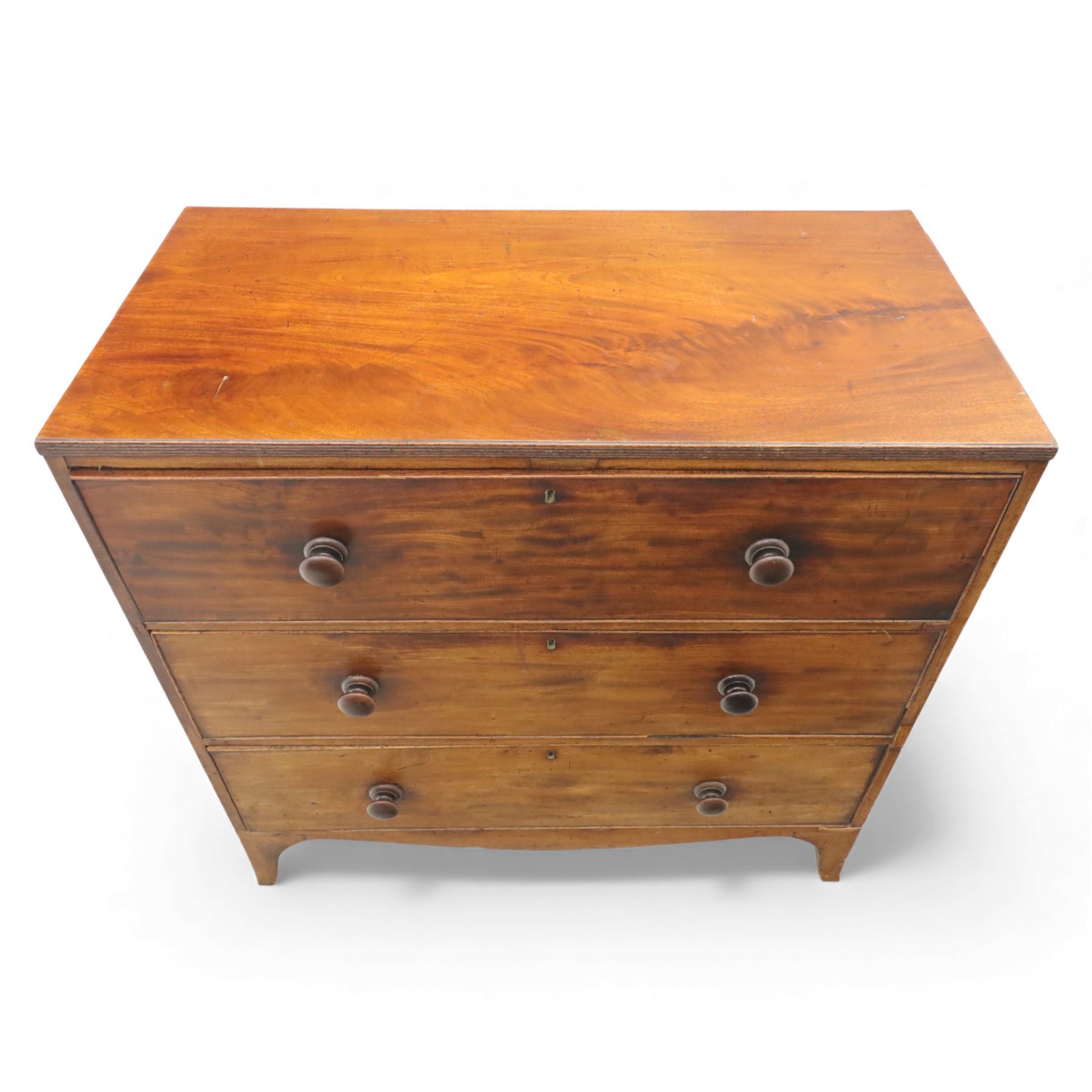 Early 19th century mahogany secretaire chest, the rectangular top over a fall-front fitted with pigeonholes and small drawers, above two long drawers with turned wooden knobs, upon swept bracket feet