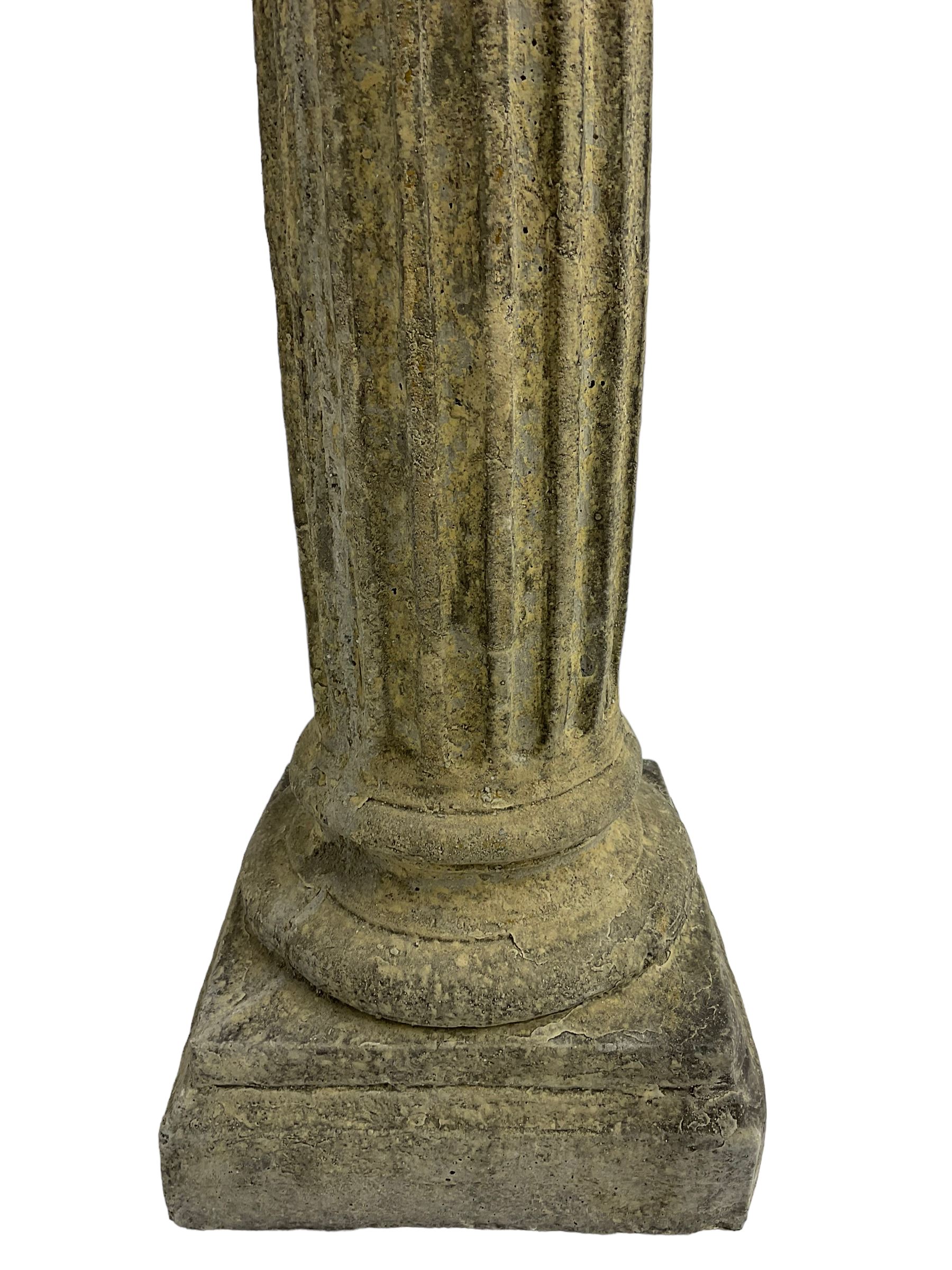 Classical design cast stone female bust depicting Artemis, raised on fluted Corinthian column with acanthus leaf capital, stepped square base, looking right 