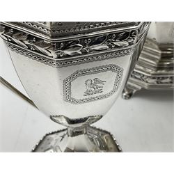 Victorian silver four piece tea service, comprising teapot, teapot stand, twin handled open sucrier and milk jug, each of octagonal form with foliate bud border and engraved decoration including crest to canted panels, and vacant panels, the teapot with ivory finial to the hinged cover and later wooden handle, hallmarked Edward Barnard & Sons Ltd, London1896, teapot including finial H15cm, milk jug including handle H16cm, teapot stand W11.5cm

This item has been registered for sale under Section 10 of the APHA Ivory Act