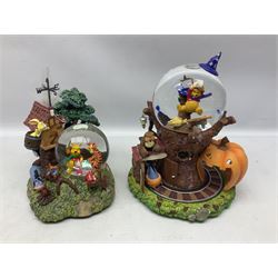 Six Disney Winnie The Pooh snow globes, to include four Halloween examples, including Tigger's Haunted House, together with Winnie The Pooh Gazebo snow globe and Bonfire snow globe, all with boxes