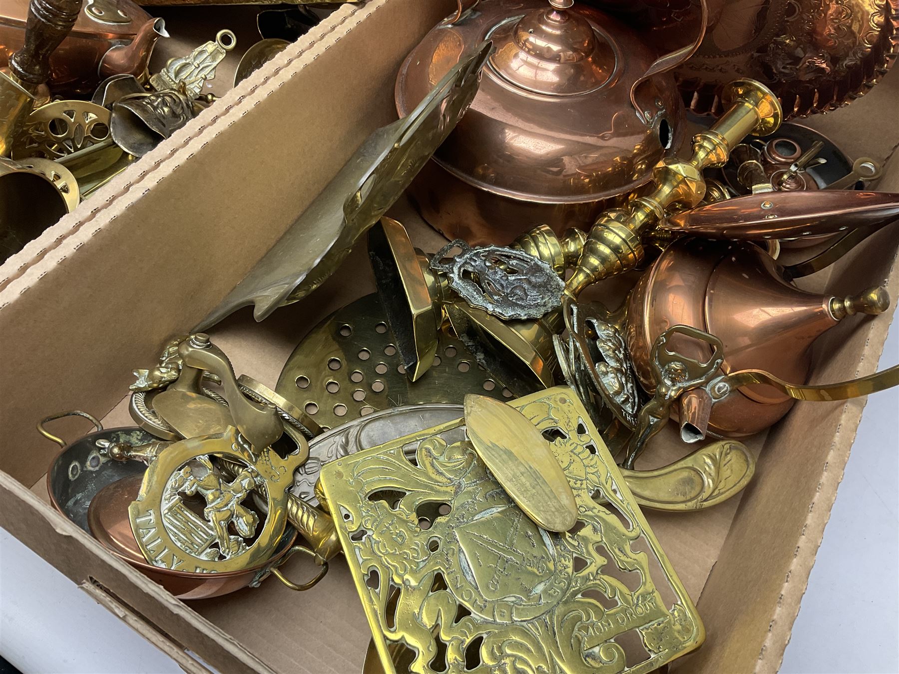 Quantity of copper pans and teapots, dish and sieve with pierced heart decoration and brass handle, together with quantity of brassware to include brass Art Nouveau crumb tray and brush, repousse chargers, fire tool accessories, decorative canon, sword and guns etc