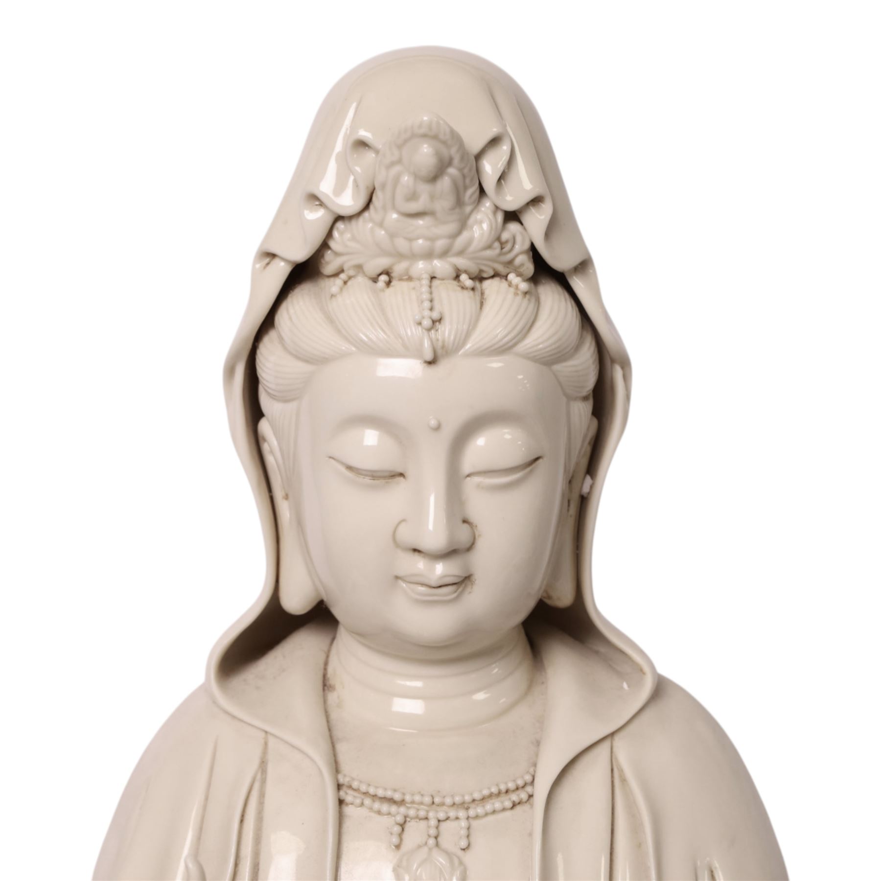 Large Chinese blanc de chine figure of Guanyin, depicting the goddess stood upon a lotus leaf with one hand raised, with potters seal mark to the reverse, H75cm
