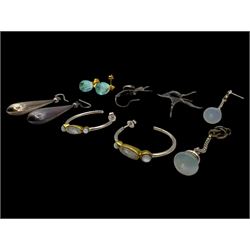 Six pairs of silver earrings, including opal pendant earrings and a pair of moonstone hoop earrings