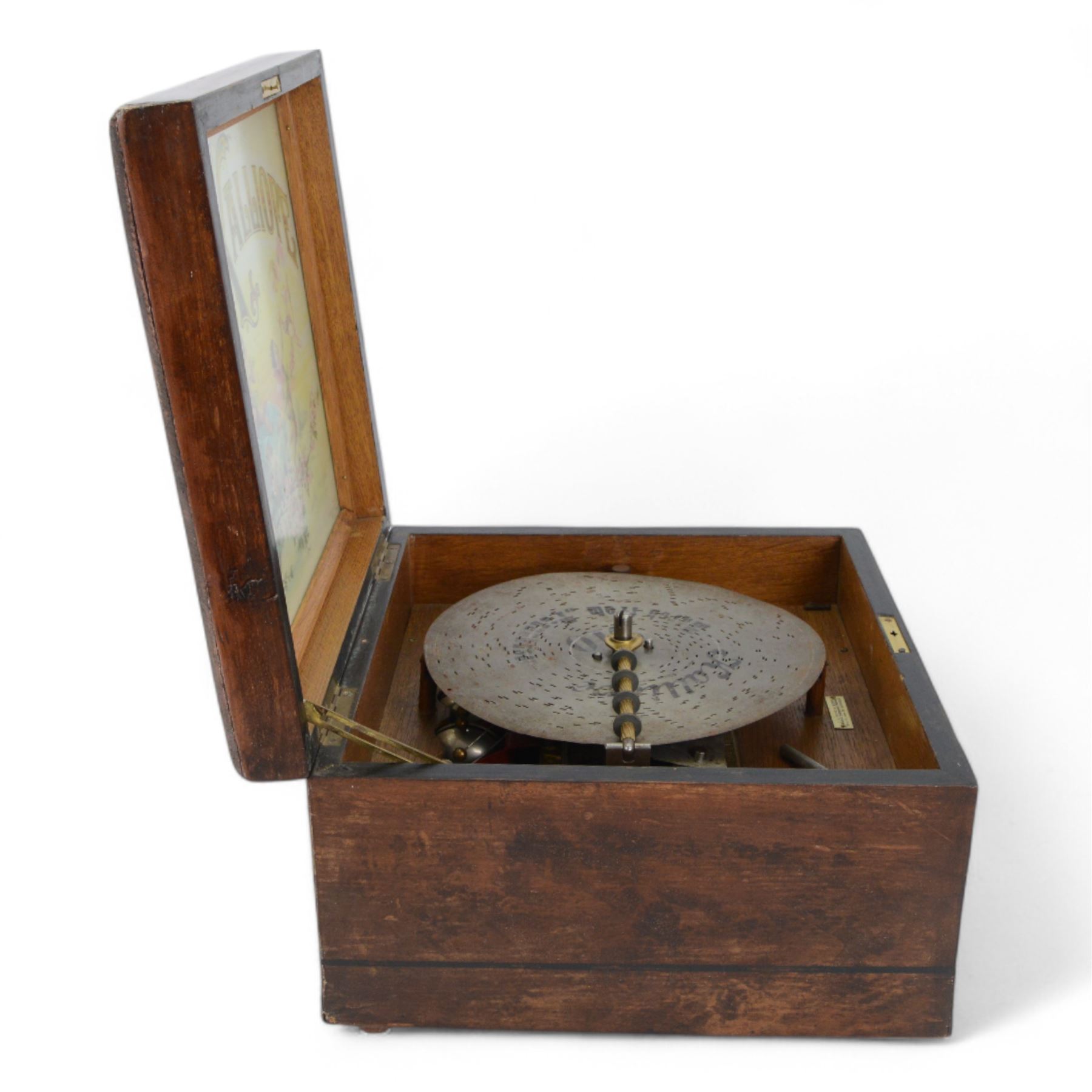 German-late 19th century Polyphon, in a mahogany finished case with a decorative inner Kalliope trade decal, with a 48 tooth steel comb on a gilt cast base and central driving spindle, with six bells and hammers and one 9-1/8” disc. Serial No 113007. With Key.