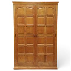 Beaverman - oak double wardrobe, enclosed by twin multi-panelled doors, Yorkshire Rose carved handles, the interior fitted with shelf and hanging rail, with signature carved beaver, by Colin Almack of Sutton, near Thirsk