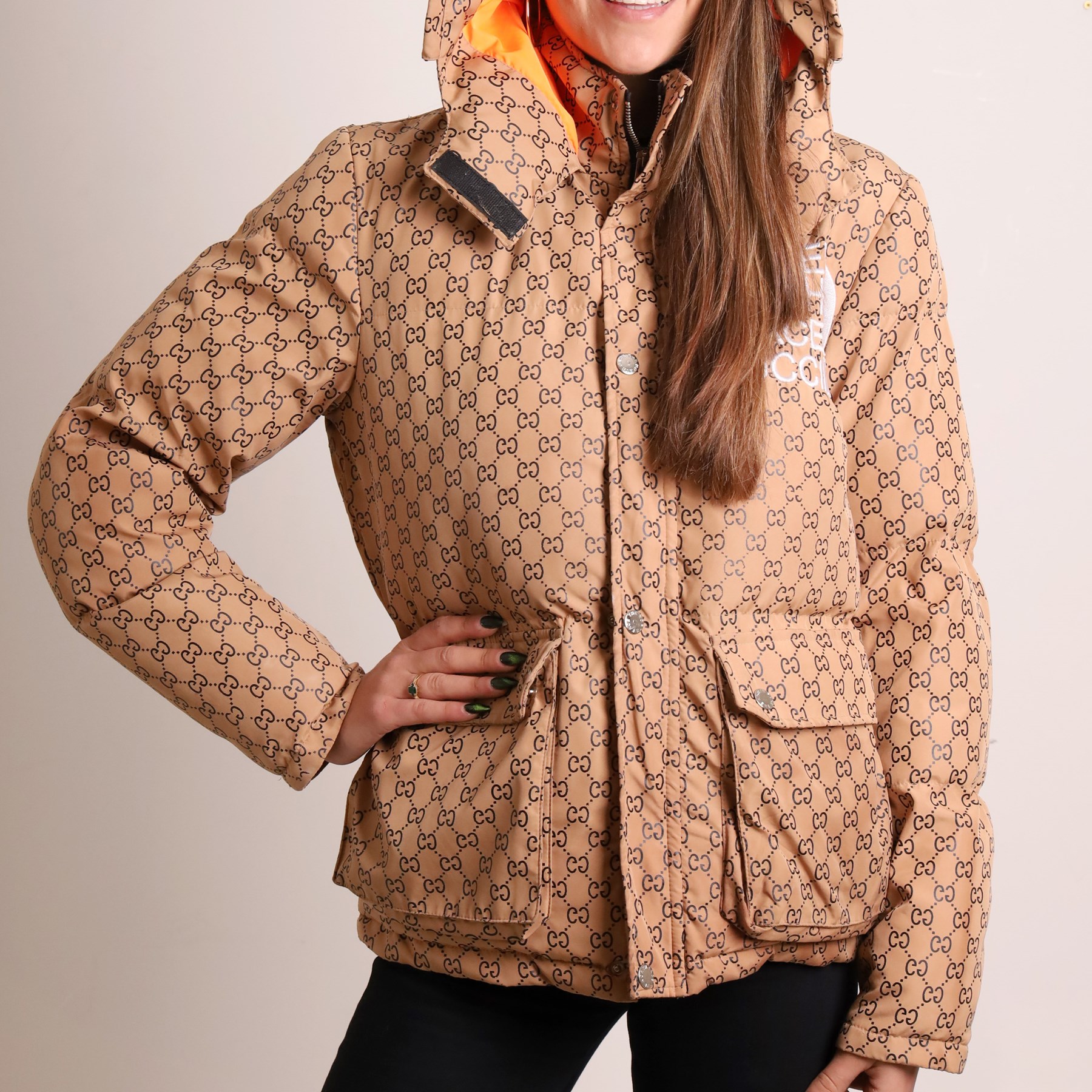 Gucci x The North Face – monogram hooded puffer jacket, beige and ebony GG monogram fabric with embroidered Gucci x The North Face logos to the chest and interior collar, detachable/adjustable hood, zip fastening with silver tone press-studs, flap pockets and vivid orange lining, size S