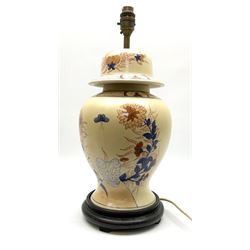An Oriental style table lamp modelled as a ginger jar, with foliate decoration in blue and red, including fixtures H43.5cm.