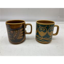 Collection of 1970s Hornsea mugs designed by John Clappison, comprising six Train Robber pattern examples together with owl patterned example on dark teal ground, and further example decorated with stylised hen and chick and egg, approx 9cm, together with four small cup bowls, all with stamped Hornsea marks beneath