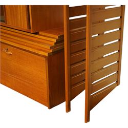 Ladderax - mid 20th century teak modular wall unit, comprising two sliding door cabinets, one fall-front cabinet, six shelves, four ladder supports and fourteen metal cross braces