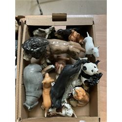 Two boxes of animal figures to include mainly ceramic and composite examples, to include dogs, lion, hippo, etc