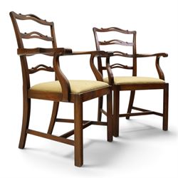 Pair of Georgian design Chippendale style mahogany elbow chairs, the pierced and waived ribbon ladder-back over scrolled arm terminals and yellow drop-in seats, on moulded and chamfered square supports