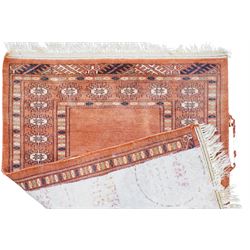 Small Afghan rust ground rug, plain field enclosed by patterned borders (94cm x 64cm); small Persian Hamadan indigo ground rug, decorated all-over with small flower head and bird motifs (118cm x 66cm); and a small Persian red ground rug (94cm x 62cm) (3)