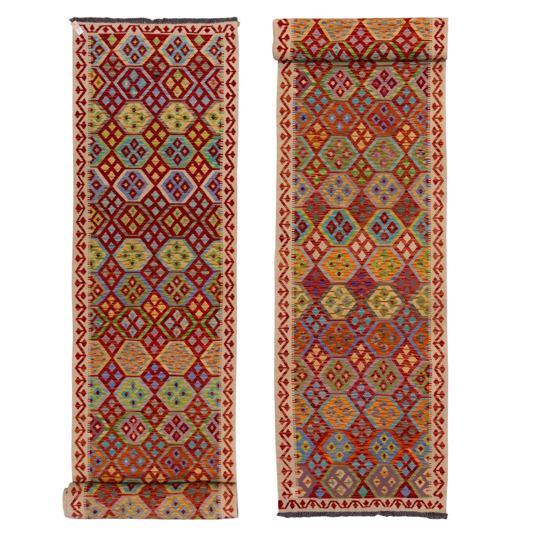 Turkish Anatolian flatweave kilim runner, ivory field decorated with rows of large polychrome lozenge medallions enclosing stylized geometric motifs with angular stepped borders, fringe ends 
