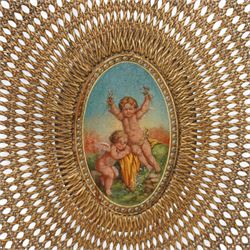 Pair of Edwardian Hepplewhite Revival green-painted open armchairs, cane work shield back with central oval panel panted with putto set upon rocky landscape with water and trees, shaped and rolled arms enclosing cane work seat, on turned front supports decorated with acanthus leaves and draped festoons 