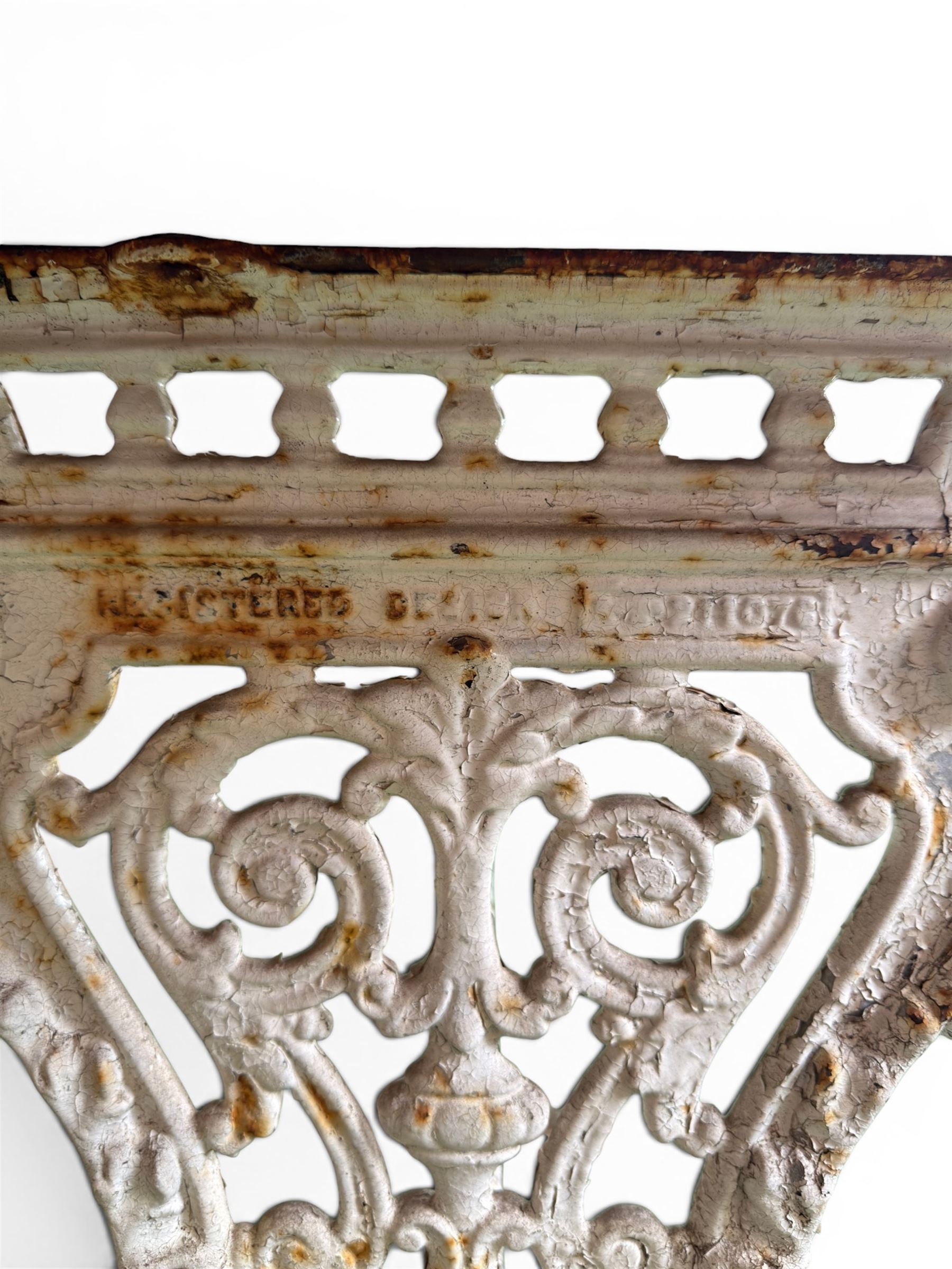 Victorian ornate cast iron garden table, trefoil base with central enclosed column, circular top with later marble, with registration mark