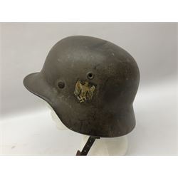 WW2 German single decal combat helmet, possibly M35, with liner and strap; impressed to skirt EF62 and 700