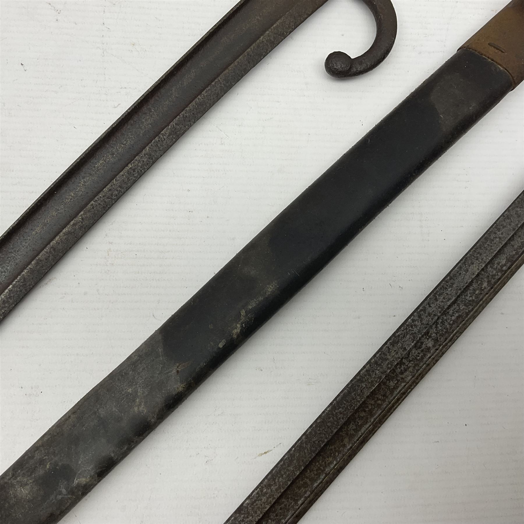 WWI Remington Pattern 1913 bayonet, the 43cm fullered blade with various marks to the ricasso including date code 11 16; in leather covered scabbard with various stamps including JWB 17 L58cm overall; and a French Model 1866 sabre bayonet (no scabbard)