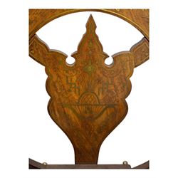 Late 20th century brass inlaid hardwood throne chair, curved X-frame form, raised shaped back inlaid with trailing leafy branches and flower heads, on sledge feet 