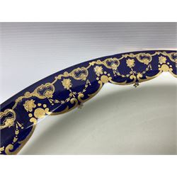 Early 20th century Bishop and Stonier four piece toilet set, comprising washbowl, wash jug, toothbrush pot, and chamber pot, each  decorated with deep blue band and husk swags and festoons in gilt, with printed Caduceus Bisto marks beneath and printed retailers mark 'Manufactured for Harrods Limited London', wash bowl D43cm, wash jug H31.5cm