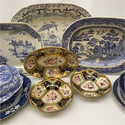  A selection of blue and white pottery, comprising four meat platters,  a Victorian drainer, two tureen and covers, one of rounded square form, the other of circular form, a Booths presentation plate, together with a further tureen and cover with stand, and a set of three dishes with hand painted floral and gilt decoration.   