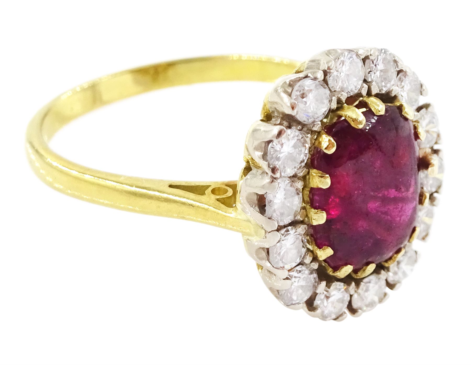 18ct gold garnet and diamond cluster ring, single cabochon cut garnet surrounded by twelve brilliant cut diamonds, London 1970, total diamond weight approx 0.60 carat 