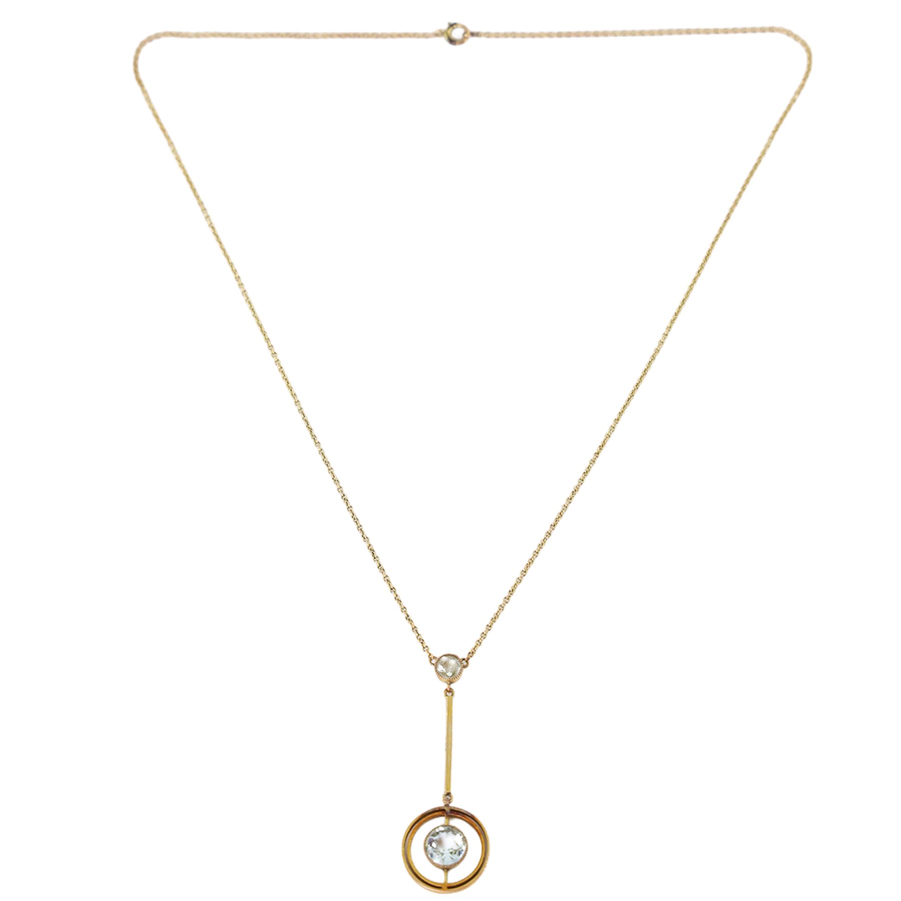 Early 20th century gold aquamarine pendant necklace, milgrain set round cut aquamarine within a pierced circular setting, to a smaller round cut aquamarine, on a fine trace link chain necklace, stamped 9ct, in a velvet and silk lined box by Leefe & Sons, Malton