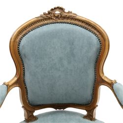 Louis XV design giltwood open armchair, shaped upholstered back with carved foliate cresting, padded scroll arms and serpentine seat upholstered in pale blue fabric with studwork, moulded and foliate carved frame, on cabriole supports with scroll feet