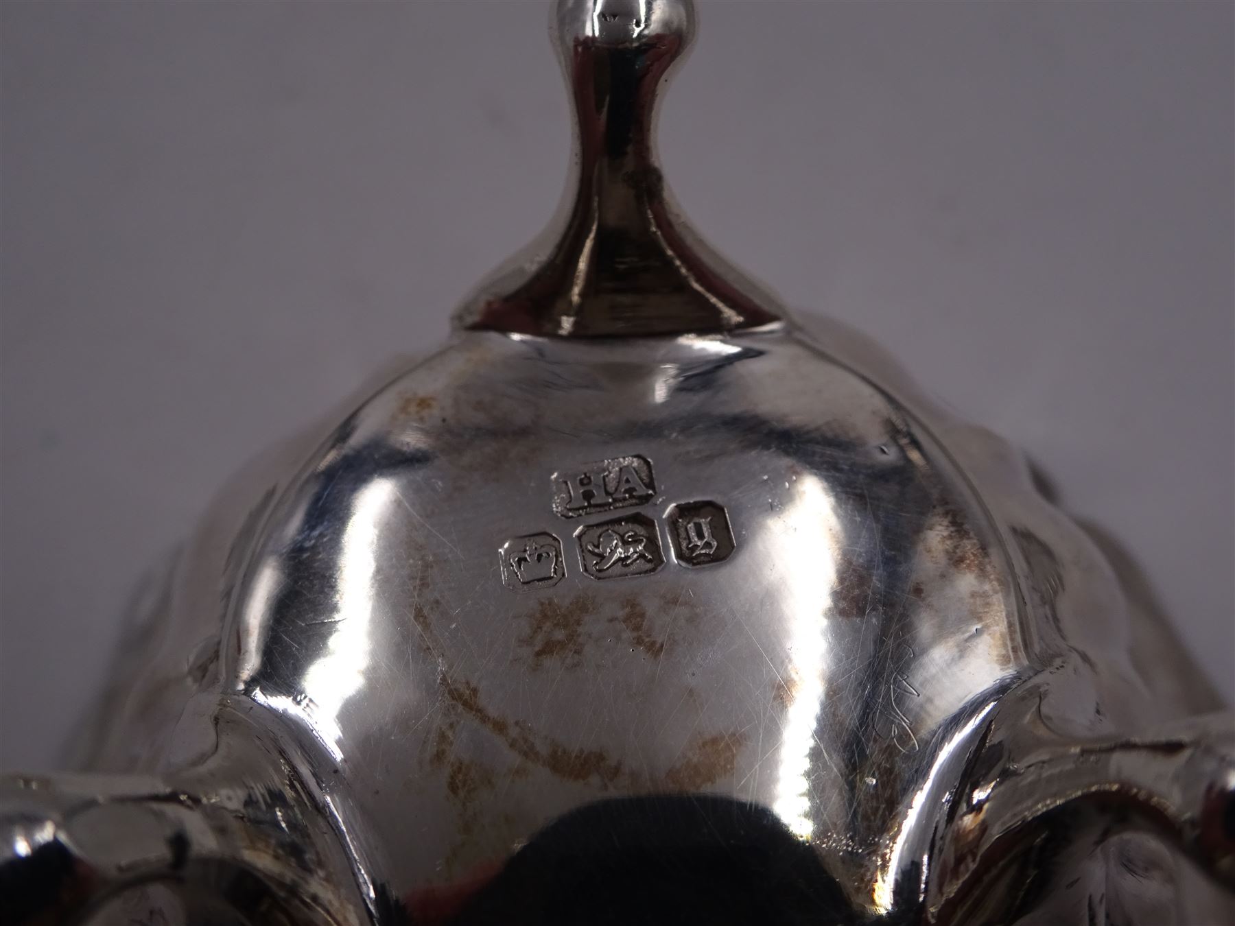 Early 20th century silver mustard pot and cover, of faceted oval form, with shaped rim and acanthus capped scroll handle, upon four pad feet, with matching spoon, H5.5cm, hallmarked I S Greenberg & Co, Birmingham 1912 & 1914, with blue glass liner, together with pair of Victorian silver open salts, of fluted circular form, with lobed rim, upon three pad feet, with matching salt spoons, all hallmarked Atkin Brothers, Sheffield 1899 and a Victorian silver pepper, of waisted baluster form, the part fluted body repousse decorated with flowers and leaves and a floral garland to upper rim, hallmarked William Oliver, Birmingham 1900