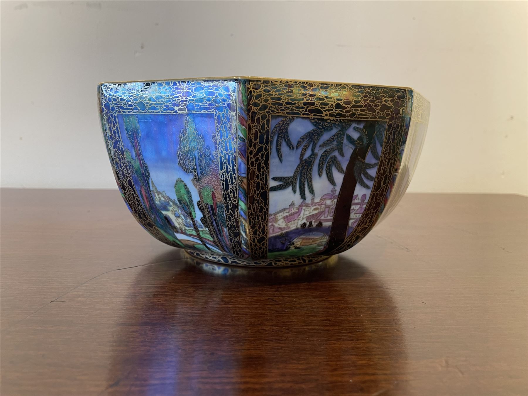 Early 20th century Wedgwood Fairland lustre bowl, circa 1920, of octagonal form, designed by Daisy Makeig-Jones, the exterior decorated in the Castle on the Road pattern, the interior decorated in the Fairy in a Cage pattern, pattern no Z5125, with printed marks beneath, H11cm D22.5cm
