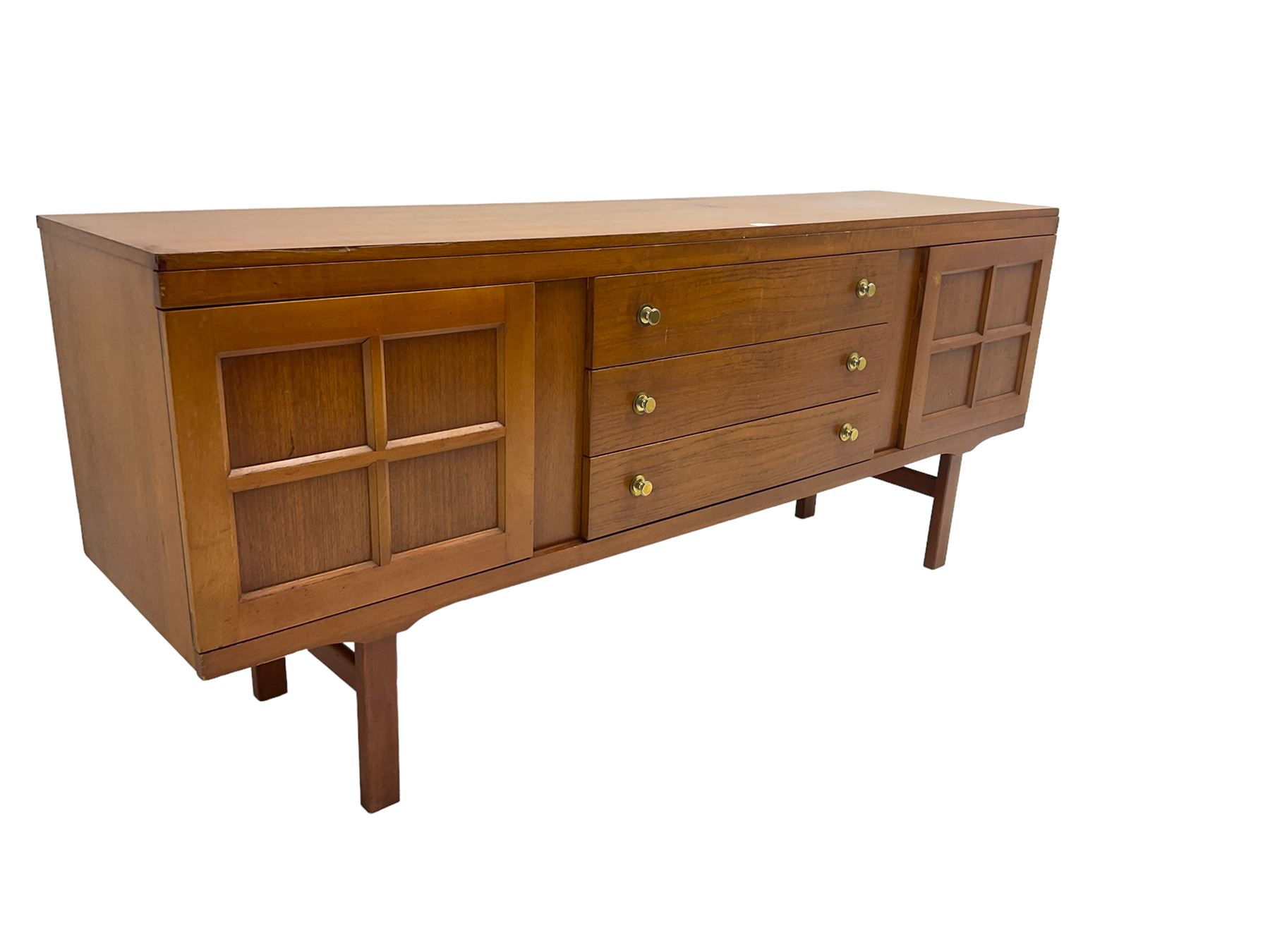 Elliotts of Newbury (EoN) - mid-20th century teak sideboard, fitted with three central drawers flanked by two cupboards, raised on square supports 