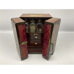 19th century mahogany travelling apothecary cabinet, with recessed brass carry handle to top, and twin deep section doors to front, opening to reveal a fitted interior containing sixteen clear glass bottles, many with labels, and two pull out drawers with turned ivory handles containing further bottles and jars, glass mixing bowl and various accessories including a balance scale, H27cm W22cm D17.5cm