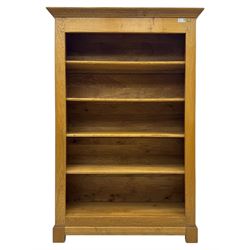 Contemporary French provincial design oak open bookcase, with projecting moulded cornice above a boarded back, fitted with four adjustable shelves, on bracketed plinth base