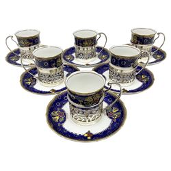 Set of six Bisto coffee cans and saucers, with foliate decoration on a blue ground with a gilt boarder, the cans within silver mounts, hallmarked Charles S. Green & Co, Birmingham 1930, with original box 