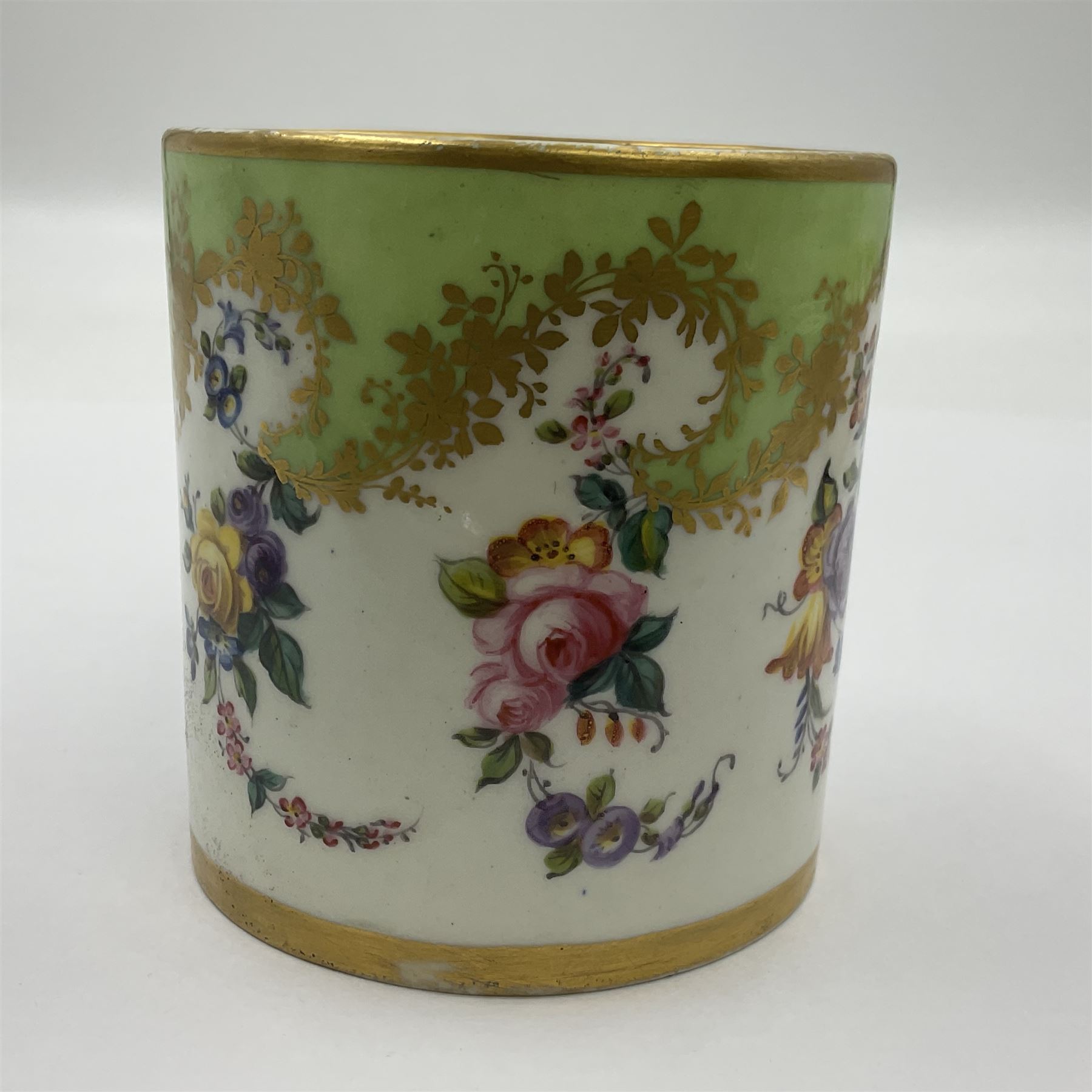 Sèvres soft paste porcelain coffee can and saucer with date code for 1754, painted and gilded with flowers, dangling from the shaped green border, interlaced LL monogram enclosing the date letter A above painters mark for Dodin, coffee can H7cm, saucer D14.5cm