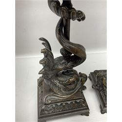 Pair of late 19th/ early 20th century brass candlesticks in the form of dolphins upon a stepped base with Fleur-de-lis design, H32cm 