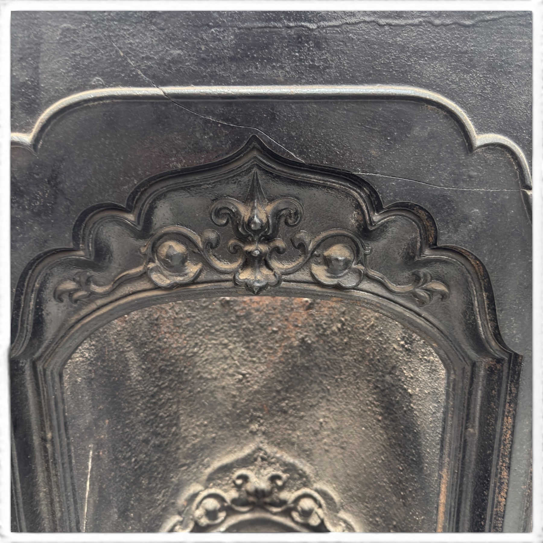 Three cast iron fireplace fittings, comprising a Regency-style fire grate with sunburst crest, urn finials, bowed basket and scroll supports (W58cm H63cm); Victorian fender with pierced acanthus frieze and foliate base (W64cm H20cm); Gothic Revival fireplace with fleur-de-lis crest, arched surround and integral fire basket (W41cm H87cm)