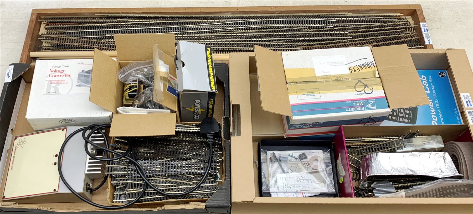 Power Units and controllers including NCE Power Cab complete DCC Starter Set, Graham Farish Powerbox 0192, Radio Shack Foreign to US Voltage Converter, Kadee Electrical Uncoupler, switch motors etc, all boxed; and quantity of Peco and other HO/00 track, points, turnouts etc