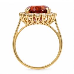 18ct gold citrine and diamond cluster ring, single oval cut citrine of approx 6.90 carat, surrounded by twenty round brilliant cut diamonds, stamped, total diamond weight approx 0.60 carat