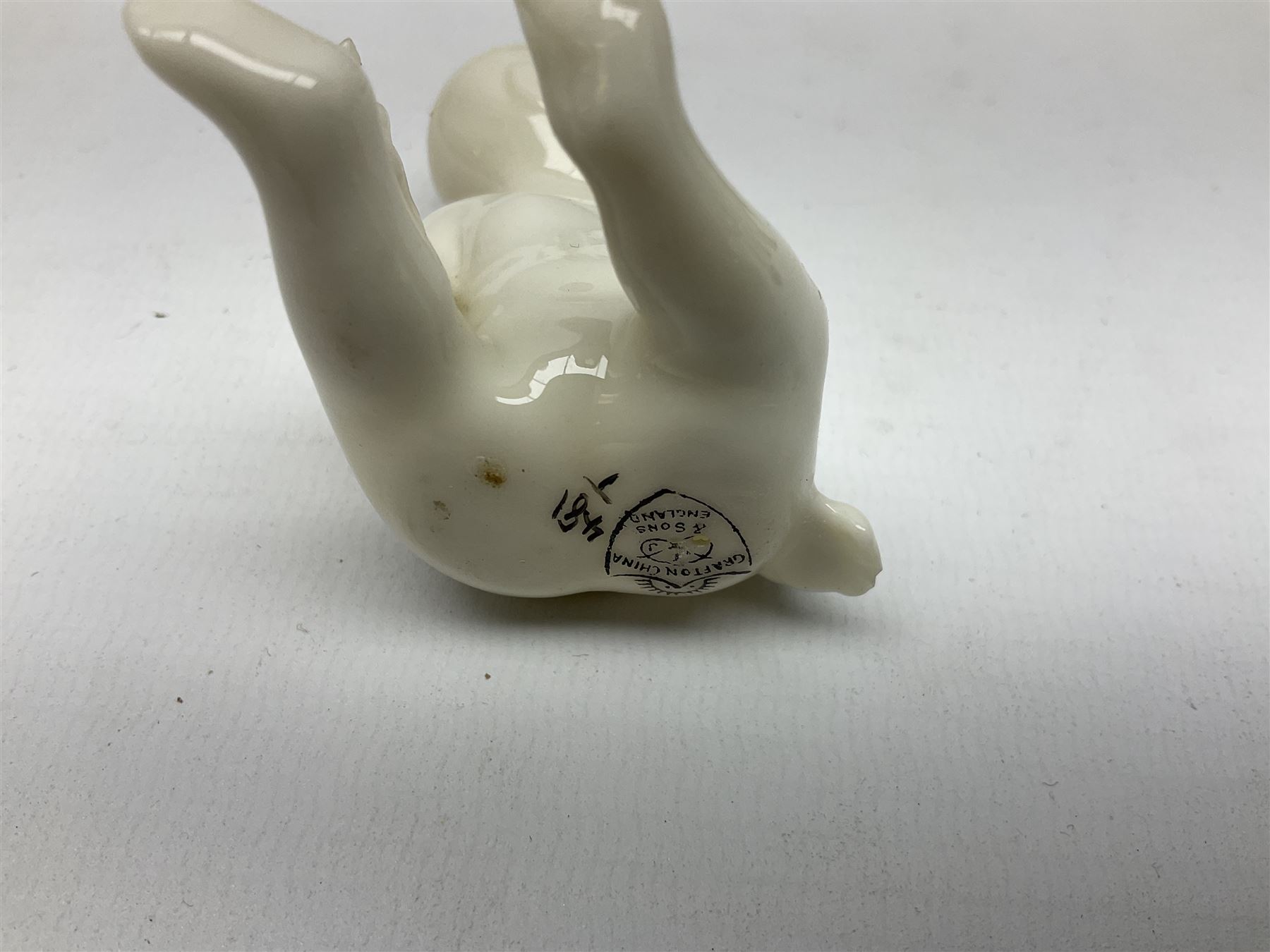 Collection of figural crested ware, to include Carlton Chins John Bull Alnwick, Clifton China Cheshire Cat,  Arcadia pig, Crafton crawling baby and another seated baby, quantity of cat, dog and pig figures, two Willow Art Model of Bunyans Statue, Toby jug, Victoria China, Arcadan bulldog, fish etc