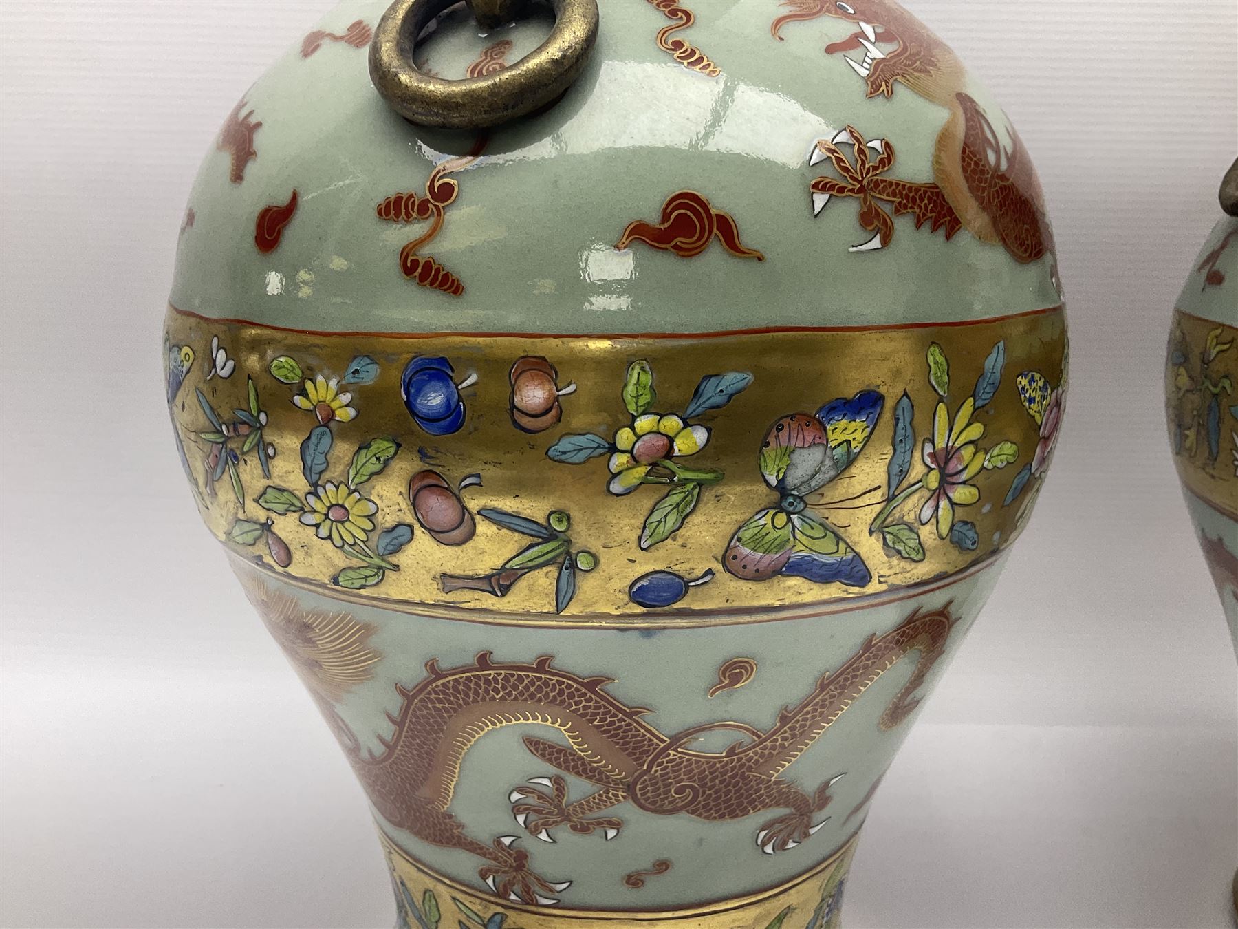 Pair of early 20th century Chinese vases decorated with dragons chasing a flaming pearl, with a gilt border of butterflies and floral sprigs, with Elephant head handles, H44cm 