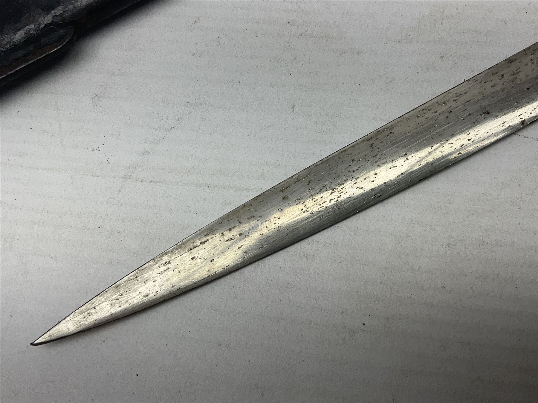 Prussian artillery officer's sword, with 80cm slightly curving fullered  blade, brass hilt with D-shaped langets, curving knucklebow, wire-bound black grip and leather finger loop; in black painted steel scabbard with single suspension loop