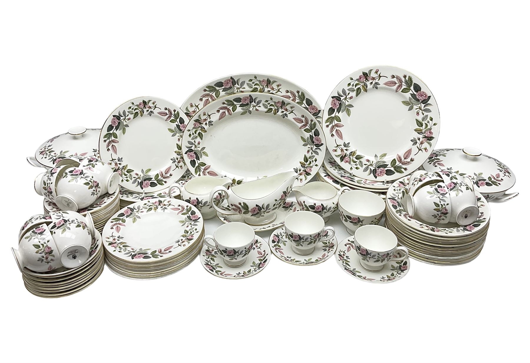 Wedgwood Hathaway Rose pattern tea and dinner wares, comprising twelve saucers, sixteen teacups, twenty tea plates, jug, sucrier, thirteen shallow bowls, sauce boat and saucer, two lidded tureens, larger jug, ten dinner plates, nine smaller plates and two large oval serving dishes