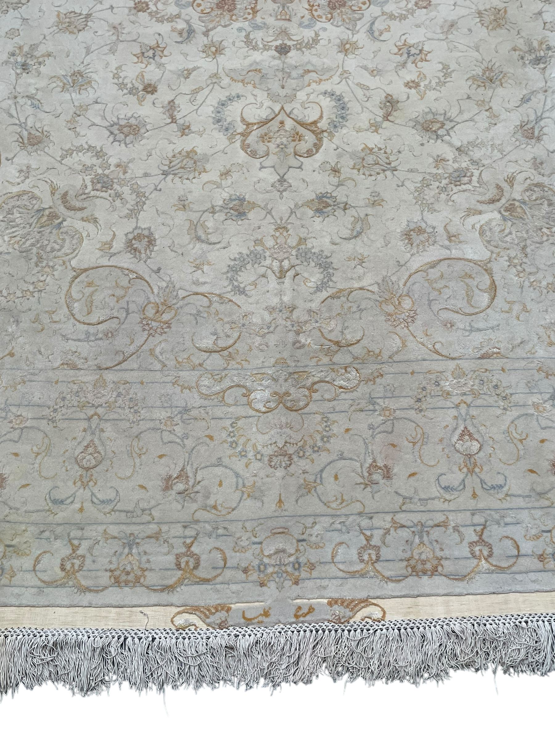 Persian Mahal densely knotted ivory ground carpet, floral rosette medallion surrounded by interlacing leafy branches and palmettes, scrolling border decorated with foliate motifs, within guard stripes, with signature panels to each end
