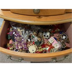 Large quantity of costume jewellery, including clip on earrings, stud earrings, rings, cufflinks and some silver Baltic amber jewellery etc, all housed within large jewellery box, with six small drawers above three larger drawers, upon four legs, and two hanging plastic jewellery holders, 