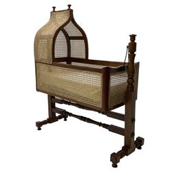 Victorian mahogany rocking crib, cane-work canape hood and sides, raised on turned und supports united by stretchers